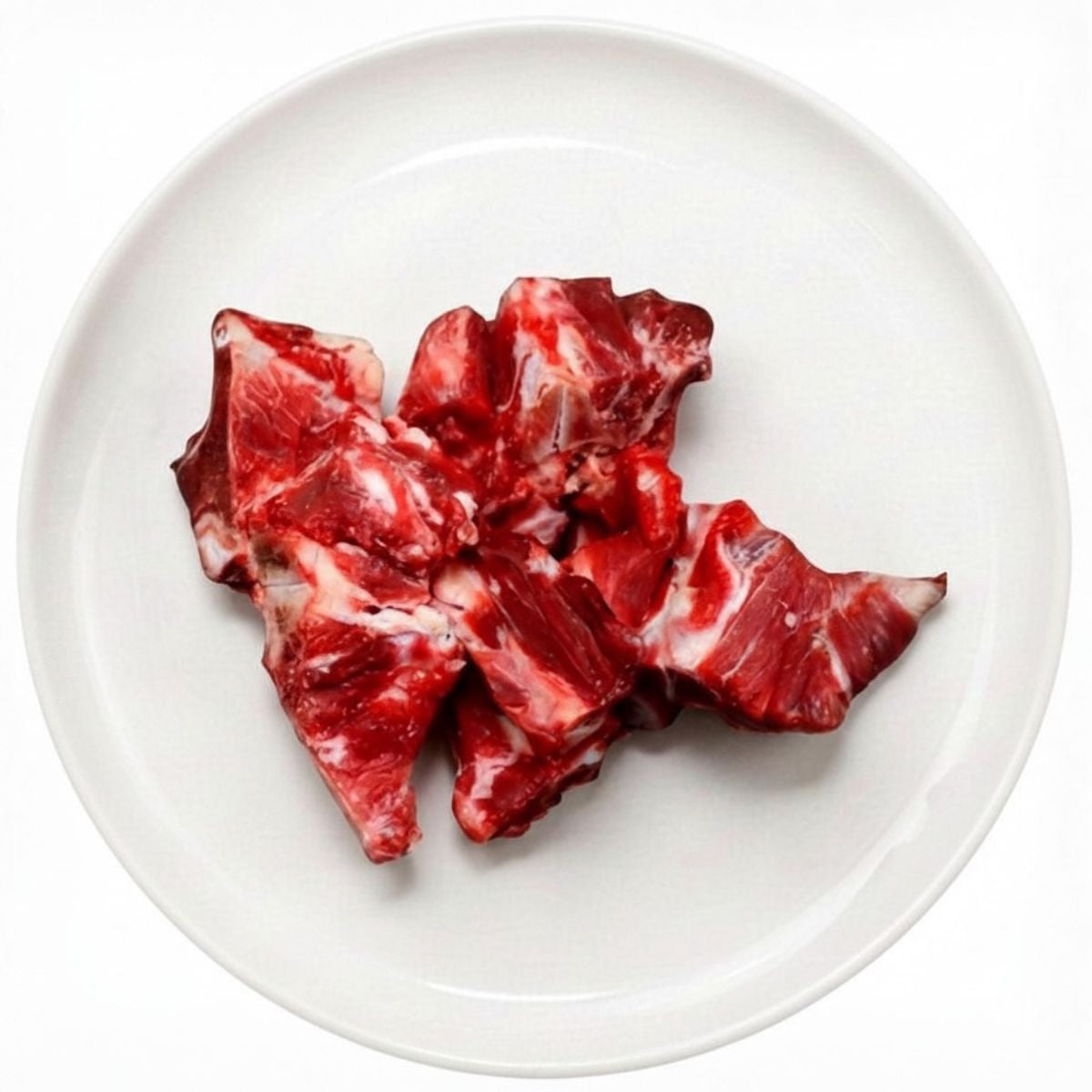 Raw cut chuck bones on a plate, raw dog food, Burleigh Bones Burleigh Heads.